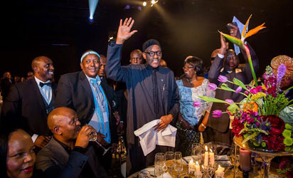 DINNER—President Muhammadu Buhari waves to other guests as he is recognized amongst other Heads of States at a dinner which took place at the International Conference Centre in Johannesburg South Africa during 25th AU Summit - See more at: http://www.vanguardngr.com/2015/06/buhari-gets-better-with-age-femi-adesina/#sthash.15L1LkJd.dpuf